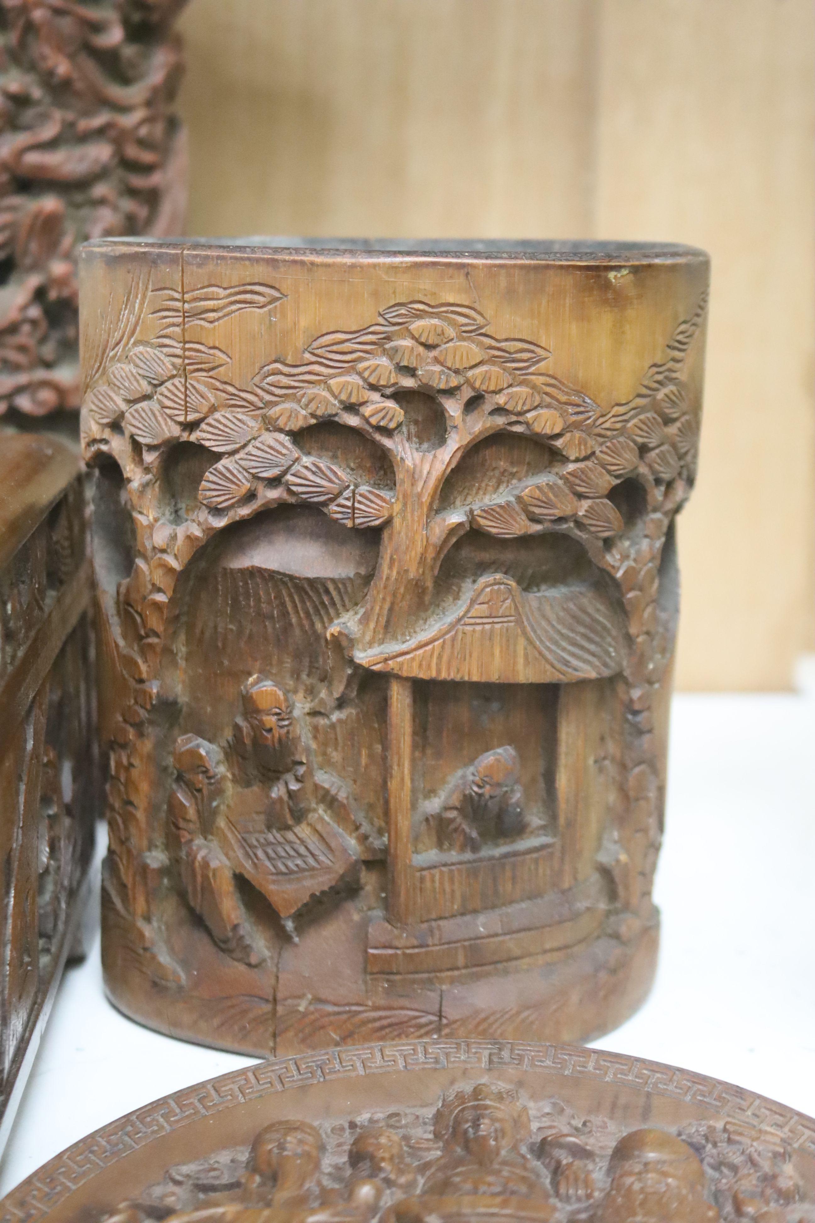 A quantity of 20th century Chinese carved bamboo and wooden effects to include a large brush pot, 17cm high (7)